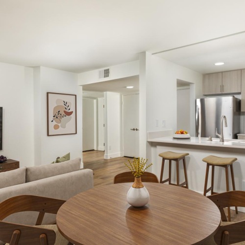 a living room with a table and chairs