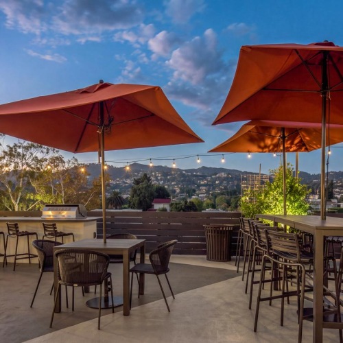 a patio with tables and chairs