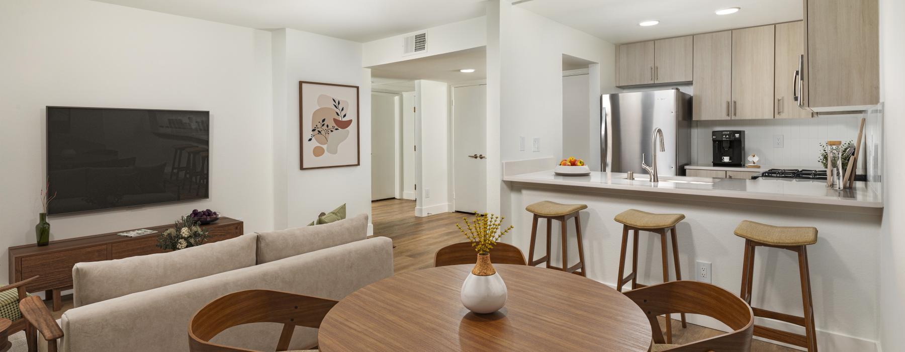 a living room with a table and chairs